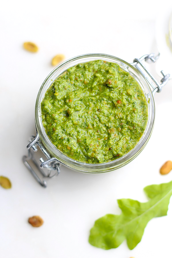 A delicious arugula pistachio pesto that makes an amazing pizza base or pasta sauce!