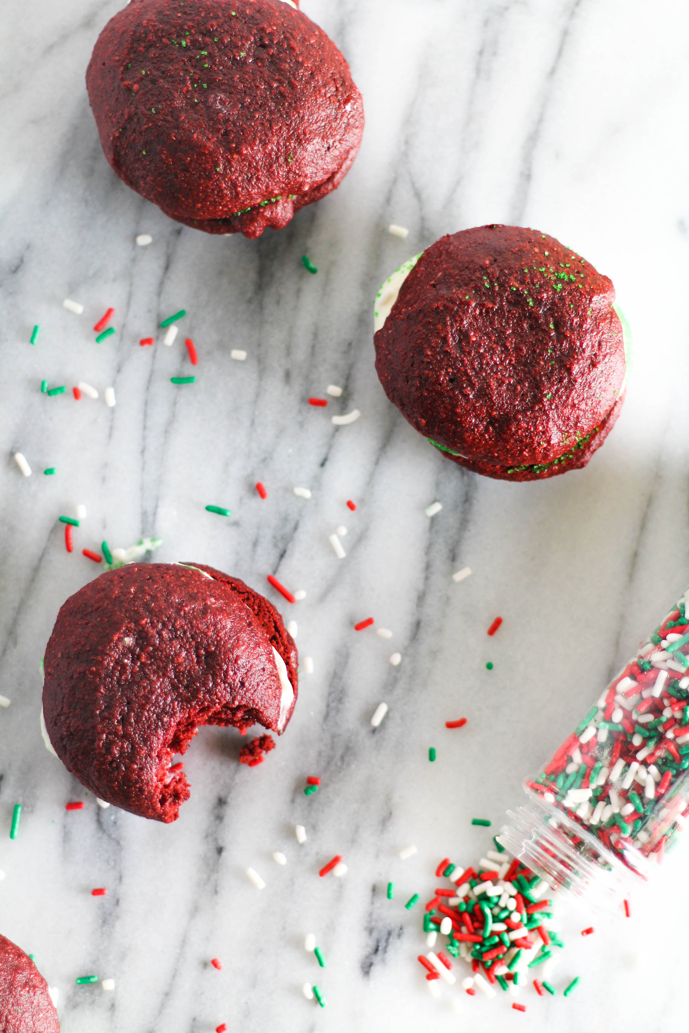 Soft, pillowy cookies sandwich a sweet and creamy cream cheese icing dipped in festive sprinkles making for an all-in-one delectable bite.