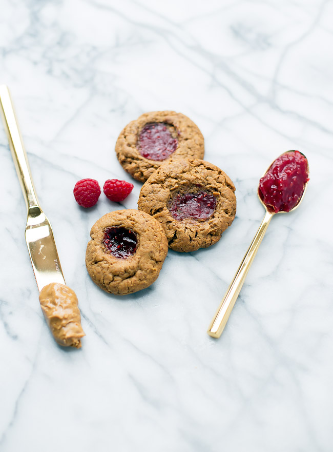 Gluten free peanut butter cookies with a kiss of jam right in the middle. Only requires six ingredients, and comes together in one bowl!
