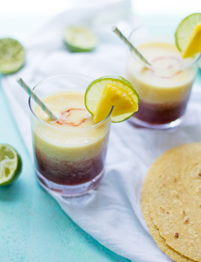 These Pineapple Cherry Margaritas are refreshing, fruity and perfect for your next celebration. They only require a few ingredients and are easy to blend up for a crowd!