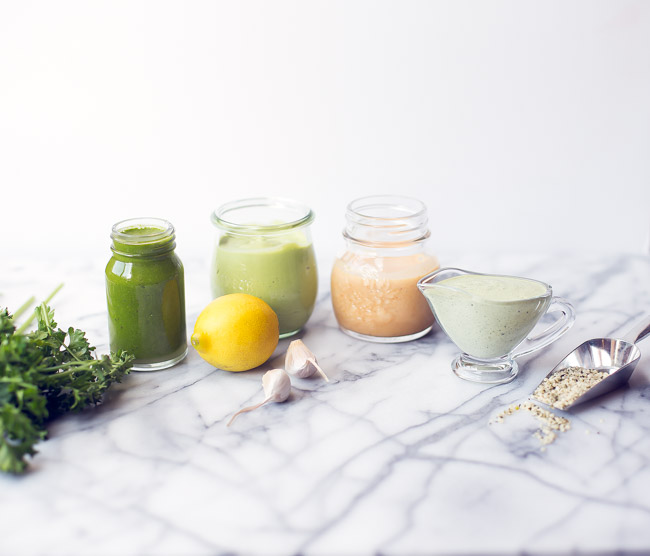 Brighten up your salad with four healthy salad dressing recipes! Garlic Basil, Herby Vegan Ranch, Avocado Cilantro, Citrus Maple Cayenne.