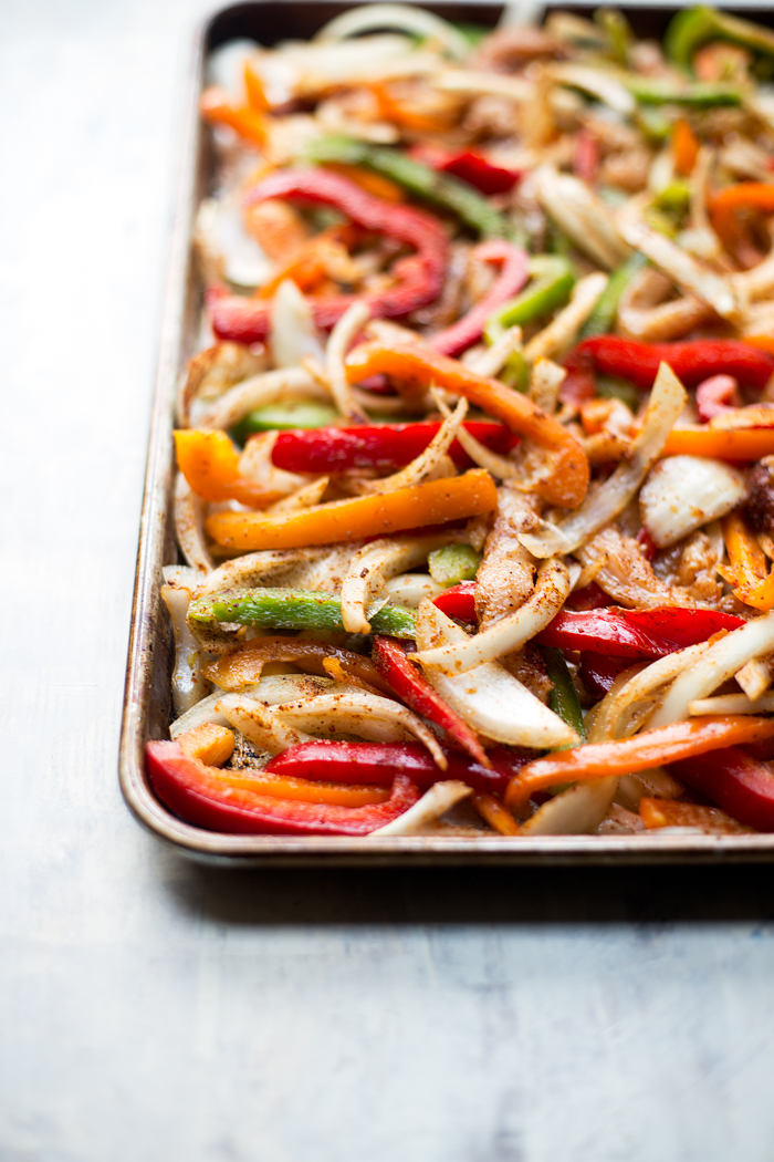 These healthy sheet pan chicken fajitas are made with simple, clean ingredients and come together on one pan. They are easy to make, and are perfect for feeding a crowd!
