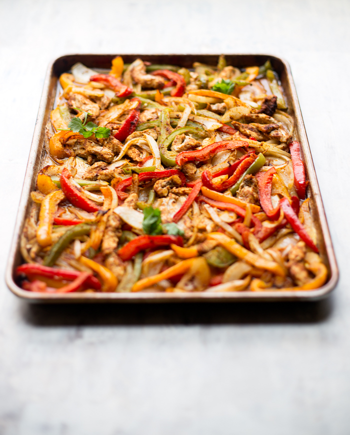 These healthy sheet pan chicken fajitas are made with simple, clean ingredients and come together on one pan. They are easy to make, and are perfect for feeding a crowd!