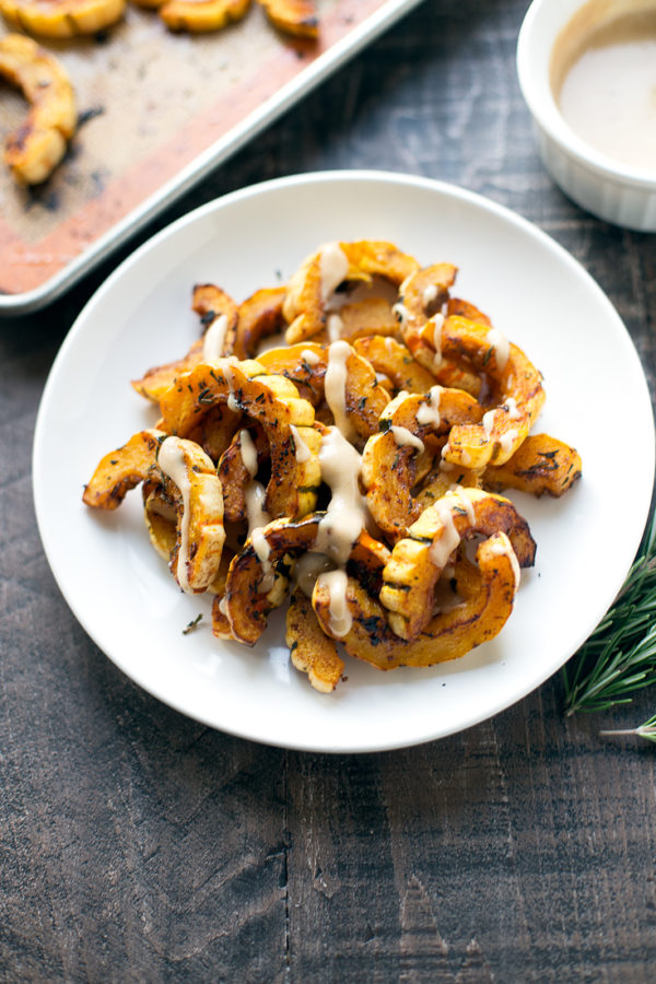 This sweet and savory roasted delicata squash makes the perfect comforting side dish! The maple-tahini sauce adds a subtle sweetness that takes it over the top.